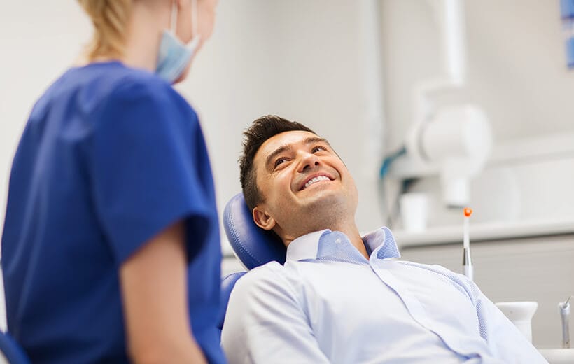 Female dentist with male patient